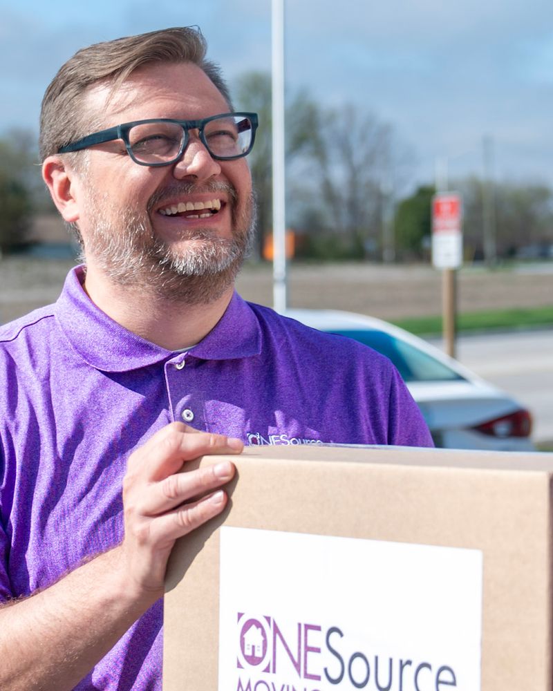 David Richardson, owner of ONESource Moving Solutions Toronto, holding a branded moving box